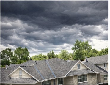 Storm clouds over neighborhood rooftops