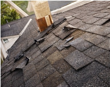 Damaged roof shingles needing repair
